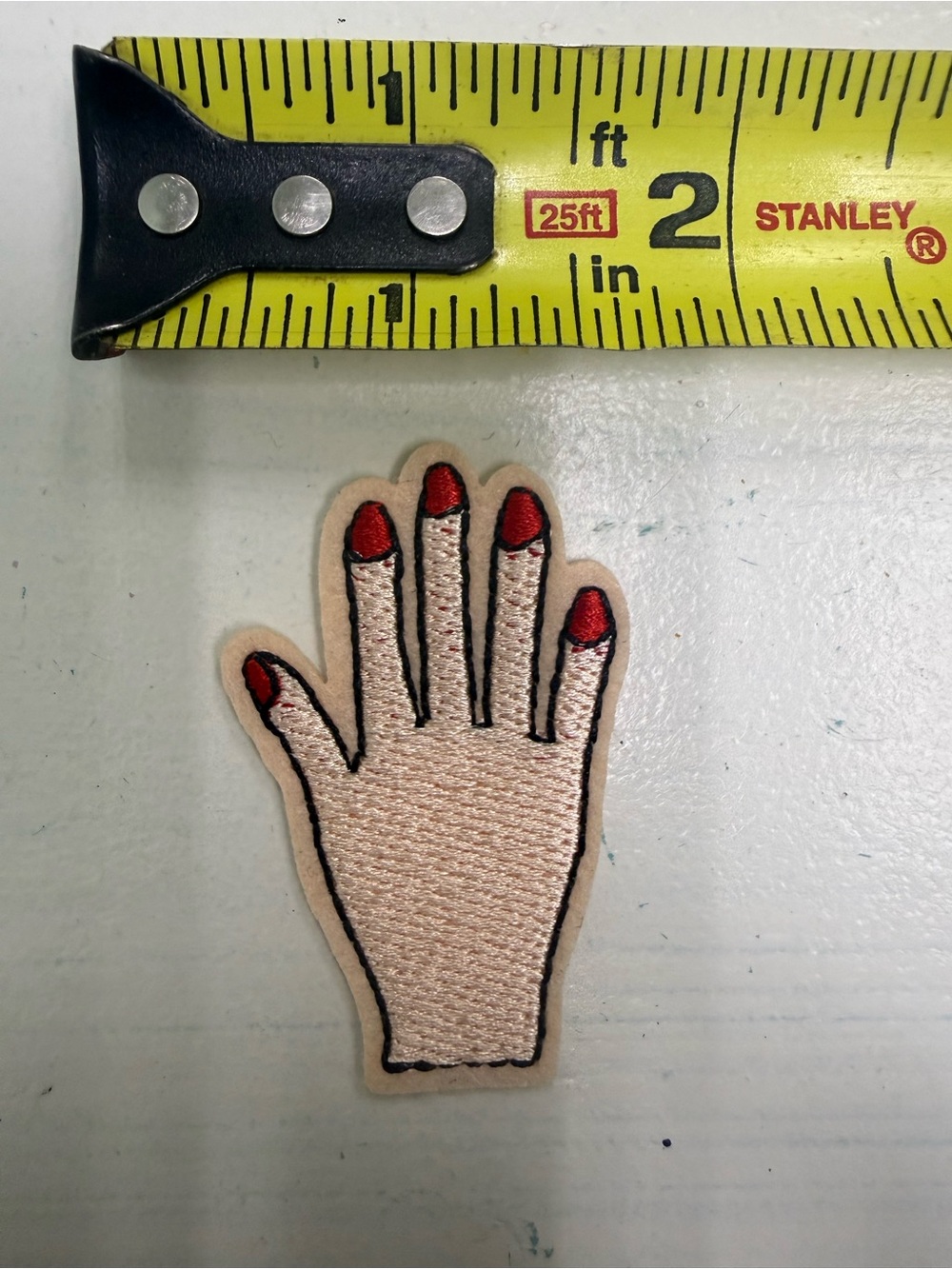 Embroidered Hand Patch with Red Nail Detail